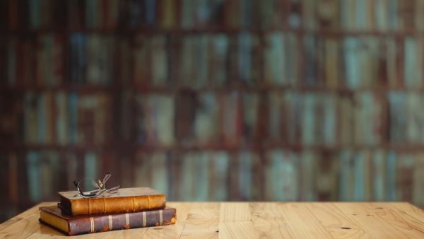 Vintage books on table in library.