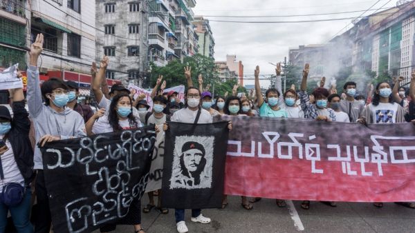 Protesters make the three-finger salute as they take part in a flash mob demonstration against the military coup in Yangon on June 14, 2021. STR / AFP Military coup in Myanmar took place on February 1st