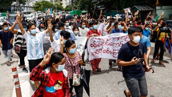 Protesters make the three-finger salute as they take part in a demonstration against the military coup and mark the birthday of Myanmar's detained civilian leader Aung San Suu Kyi in Yangon on June 19, 2021. STR / AFP Myanmar might be heading into a civil war