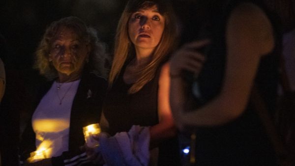 People join together in a community twilight vigil on the beach for those lost and missing during the partially collapsed 12-story Champlain Towers South condo building on June 28, 2021 in Surfside, Florida. Over one hundred people are being reported missing as the search-and-rescue effort continues. Joe Raedle/Getty Images/AFP more bodies found under the rubble in a condo tower near Miami Beach