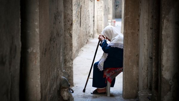 A Palestinian woman sits in the old city of the West Bank city of Hebron
