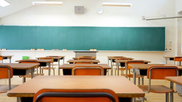 School classroom with school desks and blackboard