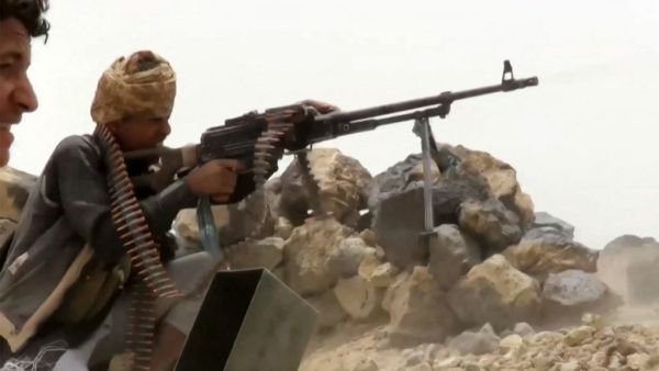 A grab from an AFPTV video shows a fighter loyal to Yemen's Saudi-backed government manning a machine gun at a position near the frontlines against the Huthi rebel forces in the region of al-Kassara,