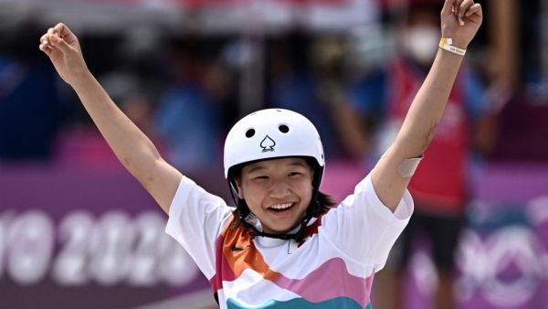 Japan's Momiji Nishiya celebrates after performing a trick during the skateboarding women's street final of the Tokyo 2020 Olympic Games at Ariake Sports Park in Tokyo 