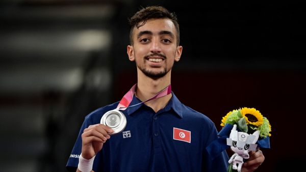 Tunisia's Mohamed Khalil Jendoubi celebrates with his silver medal on the podium after winning the taekwondo men's -58kg gold medal bout during the Tokyo 2020 Olympic Games at the Makuhari Messe Hall in Tokyo on July 24, 2021. (Photo: AFP)