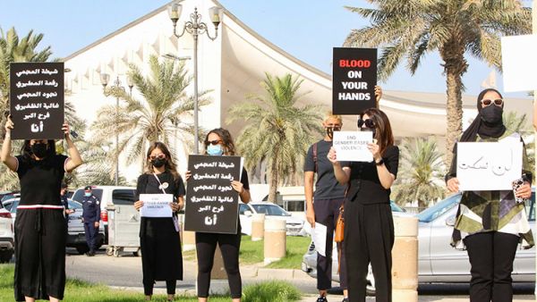 Kuwaiti women raise banners during a rally in Kuwait City. AFP