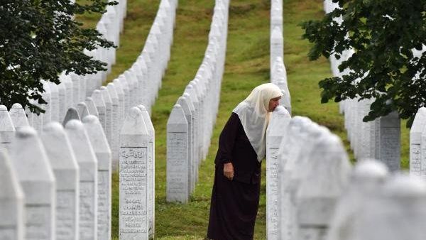  Bosnian Muslim woman Mejra Djogaz, 71, survivor of Srebrenica 1995 massacre, kisses her sons' tombstones, Omer, 19, and Munib, 21, her two sons killed in the massive killing of Srebrenica 