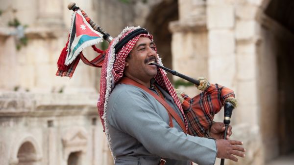  Military bagpipe player perform for tourists at the South Theatre in Gerasa, Jerash