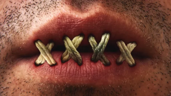Close up of mans mouth with lips stitched or sewn shut