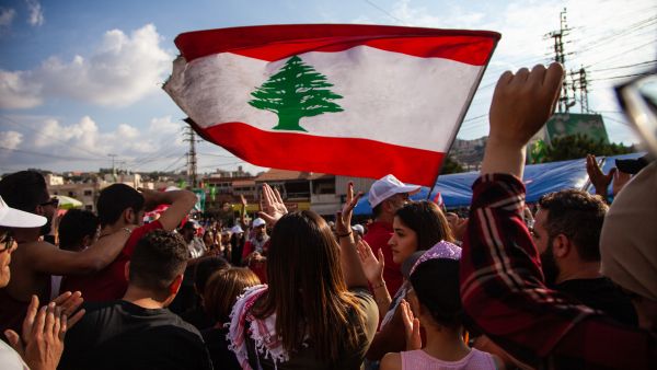 Lebanese Protesters rising Lebanon Flag