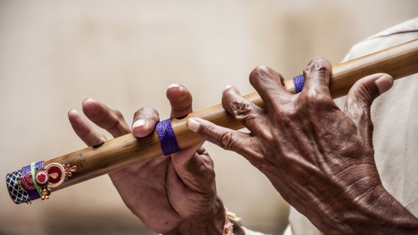Hands of a man playing a flute