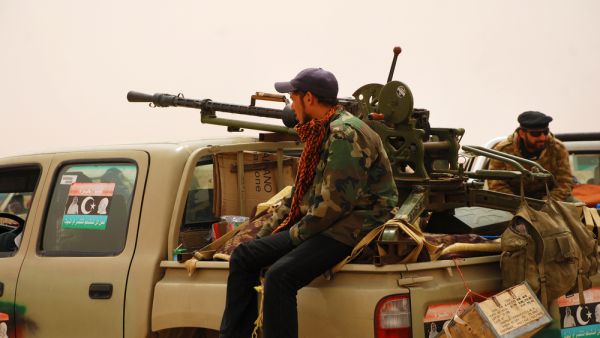 Libyan rebels travel to a battle line where they will fight  (Shutterstock) Libyan rebels travel to a battle line where they will fight
