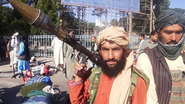 In this picture taken on August 13, 2021, a Taliban fighter holds a rocket-propelled grenade (RPG) along the roadside in Herat, Afghanistan's third biggest city, after government forces pulled out the day before following weeks of being under siege.