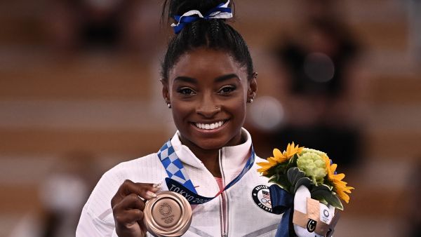 USA's Simone Biles poses with her bronze medal during the podium ceremony of the artistic gymnastics women's balance beam of the Tokyo 2020 Olympic Games at Ariake Gymnastics Centre in Tokyo on August 3, 2021. (Photo: AFP)