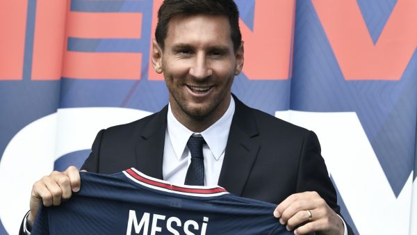 Argentinian football player Lionel Messi poses as he holds-up his number 30 shirt during a press conference at the French football club Paris Saint-Germain's (PSG) Parc des Princes stadium in Paris on August 11, 2021. (Photo: AFP)