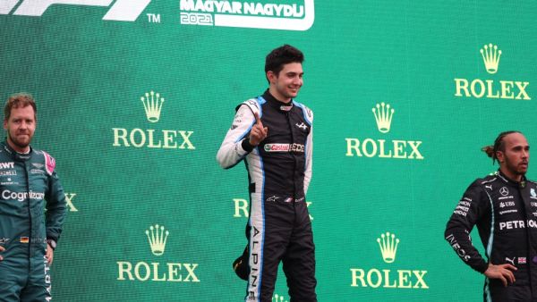 (LtoR) Second placed Aston Martin's German driver Sebastian Vettel, winner Alpine's French driver Esteban Ocon and third placed Mercedes' British driver Lewis Hamilton celebrate on the podium after the Formula One Hungarian Grand Prix at the Hungaroring race track in Mogyorod near Budapest on August 1, 2021. (Photo: AFP)
