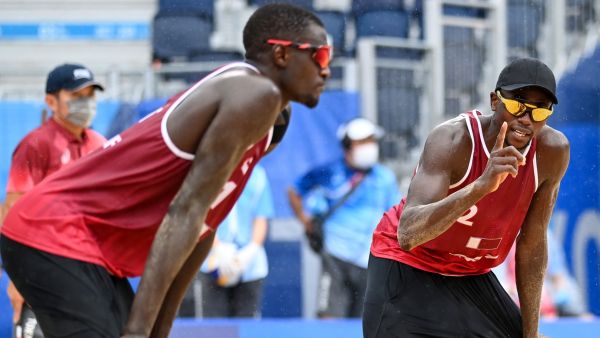 Qatar's Ahmed Tijan (R) gestures beside partner Cherif Younousse in their men's beach volleyball bronze medal match between Latvia and Qatar during the Tokyo 2020 Olympic Games at Shiokaze Park in Tokyo on August 7, 2021. (Photo: AFP)