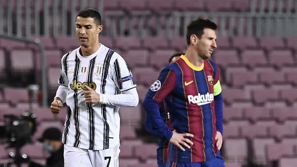 Juventus' Portuguese forward Cristiano Ronaldo (L) walks past Barcelona's Argentinian forward Lionel Messi during the UEFA Champions League group G football match between Barcelona and Juventus at the Camp Nou stadium in Barcelona on December 8, 2020. (Photo: AFP)