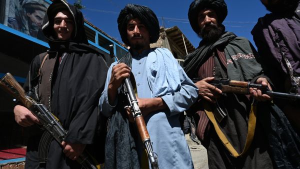 Taliban fighters pose for a picture in front of a bakery at a market area in Khenj district, Panjshir Province on September 15, 2021, days after the hardline Islamist group announced the capture of the last province resisting to their rule. (Photo by Wakil Kohsar / AFP) Taliban fighters