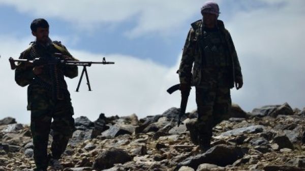  Taliban members standing in front of the gate of the Panjshir provincial governor’s compound