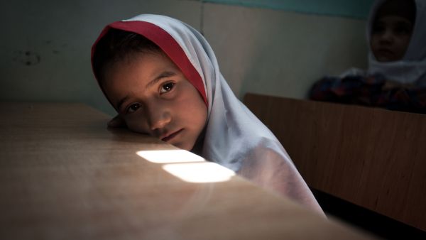 Afghan schoolchildren attend a primary school class