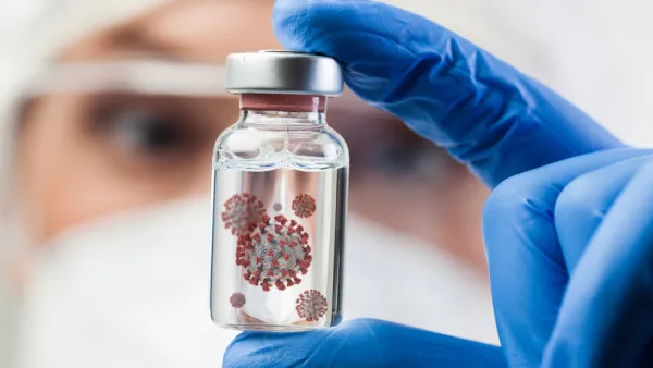 Female UK lab scientist doctor holding glass ampoule vial containing Coronavirus molecule cell