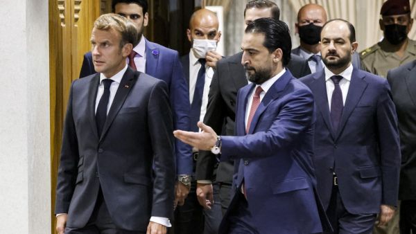 Iraqi Parliament Speaker Muhammad al-Halbousi (R) receives France's President Emmanuel Macron ahead of a meeting at the parliament in the capital Baghdad, on August 28, 2021. (Ludovic MARIN / AFP) Iraqi Parliament Speaker Muhammad al-Halbousi (R) receives France's President Emmanuel Macron