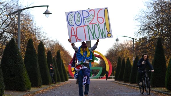 An activist holds up a placard arriving for a "Pilgrims Procession", an opening ceremony to a series of non-violent direct actions being organised by the Extinction Rebellion climate activist action group at Glasgow Green near the Scottish Event Centre (SEC) in Glasgow, Scotland on October 30, 2021. Ben STANSALL / AFP The 26th Conference of the Parties to the United Nations Framework Convention on Climate Change (UNFCCC) has been touted as a “make or break” moment for the planet.