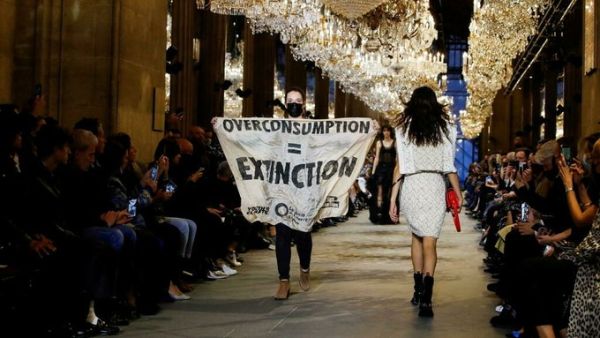 Climate change protester crashes Louis Vuitton catwalk show in Paris