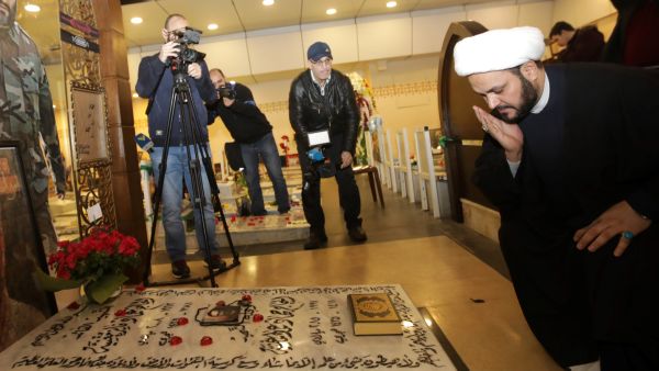 Secretary General of Shitte Iraqi Al-Nujabaa movement Akram al-Kaabi prays over the tomb of Hezbollah slain military leader Imad Moghnieh in Beirut's southern suburb on February 13, 2018. (Photo by ANWAR AMRO / AFP) Next Iraqi PM calls for canceling US-ordered agreements