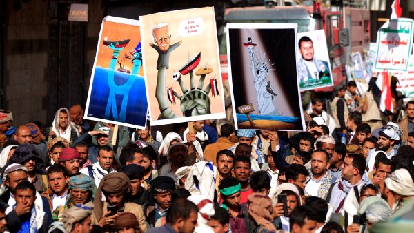 Supporters of the Yemeni Houthi rebels raise placards during a protest against the blockade imposed on their country by the Saudi coalition,in the capital Sanaa, on February 26, 2021. AFP / Mohammed HUWAIS Houthi rebels in Yemen