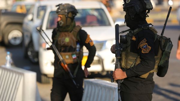 Members of Iraq's special forces stand guard during a symbolic funeral procession towards one of the Green Zone entrances in the capital Baghdad, on November 6, 2021. Ahmad Al-Rubaye / AFP A grenade blast leaves two injured in Iraq