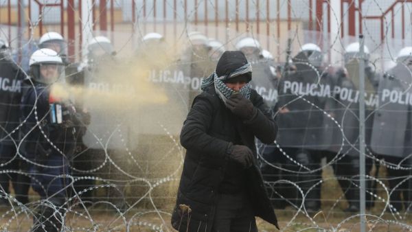 Migrants clash with Polish law enforcement officers as they attempt to cross into Poland at the Bruzgi-Kuznica border crossing on the Belarusian-Polish border on November 16, 2021. (Photo by Leonid SHCHEGLOV / BELTA / AFP) Polish military, migrants clash at Belarusian border