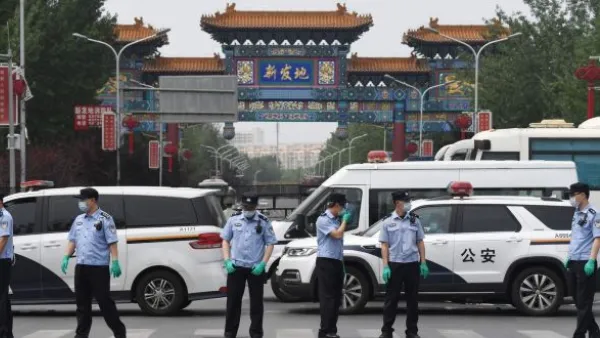Chinese police guard the entrance to the closed Xinfadi market 
