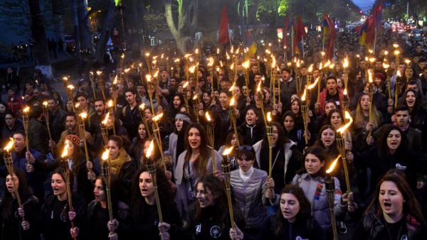 People take part in a torchlight procession