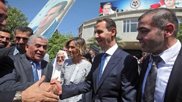 Syrian President Bashar al-Assad greets supporters 