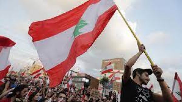 Lebanese demonstrators wave national flags on a highway linking Beirut to north Lebanon, in Zouk Mikael on October 19, 2019. (AFP) Lebanon looks for better days
