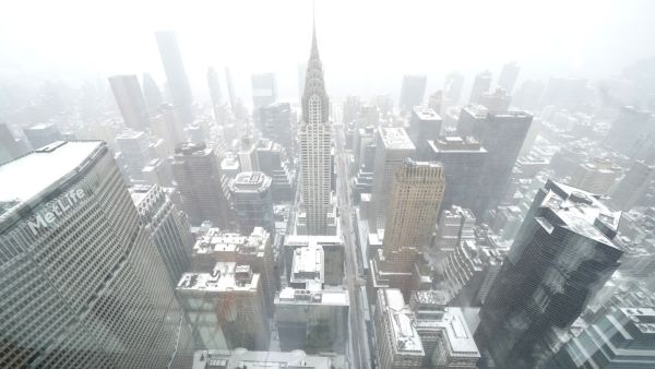 A view of the Chrysler Building (C) from The Summit at One Vanderbilt Observation Deck, during a snow storm in New York City on January 29, 2022. (Photo by TIMOTHY A. CLARY / AFP) winter storm tears through US East Coast