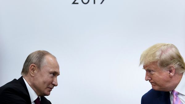 former US President Donald Trump (R) attends a meeting with Russia's President Vladimir Putin during the G20 summit in Osaka on June 28, 2019. (Photo by Brendan Smialowski / AFP) US President Donald Trump