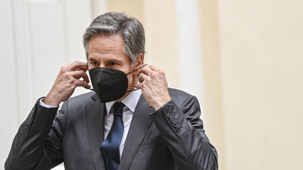 US Secretary of State Antony Blinken puts his face protection mask back on after posing for a group picture during a meeting of the Foreign Ministers of the G7 Nations at the Munich Security Conference (MSC) in Munich, southern Germany, on February 19, 2022. Ina Fassbender / POOL / AFP US Secretary of State Antony Blinken