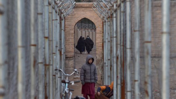 Children and women walk along a pathway near the Musalla Minarets Complex in Herat on February 5, 2022. (Photo by Wakil KOHSAR / AFP) UN calls for humanitarian aid for Afghanistan and neighboring countries