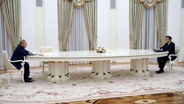 French President Emmanuel Macron (R) meets with Russian President Vladimir Putin (L) in Moscow on February 7, 2022, for talks in an effort to find common ground on Ukraine and NATO, at the start of a week of intense diplomacy over fears Russia is preparing an invasion of its pro-Western neighbour. (Photo by SPUTNIK / AFP) massive sanctions
