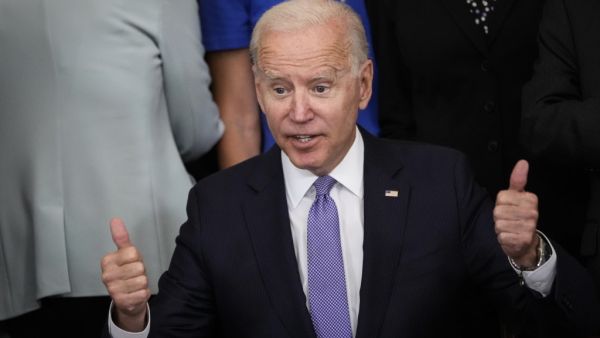 Surrounded by bipartisan members of Congress, U.S. President Joe Biden gives a thumbs up after signing the VOCA Fix to Sustain the Crime Victims Fund Act of 2021 into law in the East Room of the White House on July 22, 2021 in Washington, DC. AFP/File US President Joe Biden