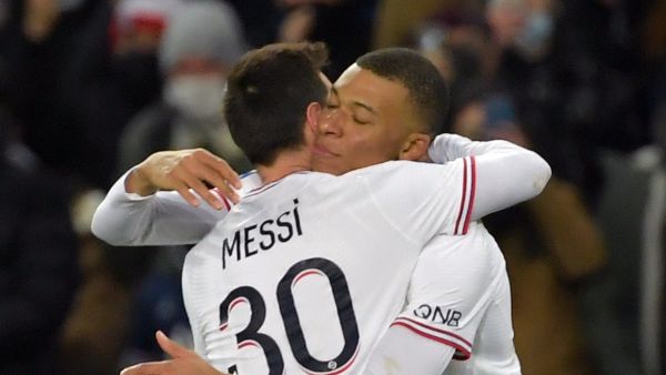 Paris Saint-Germain's French forward Kylian Mbappe is congratulated by Paris Saint-Germain's Argentinian forward Lionel Messi after scoring during the French L1 football match between Paris-Saint Germain (PSG) and Le Stade rennais Football Club at The Parc des Princes Stadium in Paris on February 11, 2022. (Photo by JULIEN DE ROSA / AFP)