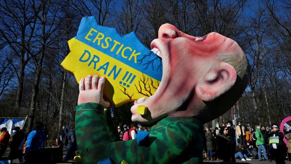 A giant figure representing Russian President Vladimir Putin swallowing a map of the Ukraine is seen during a demonstration against Russia's invasion of the Ukraine, on March 13, 2022 in Berlin. John MACDOUGALL / AFP protests continue against Russia's Ukraine invasion