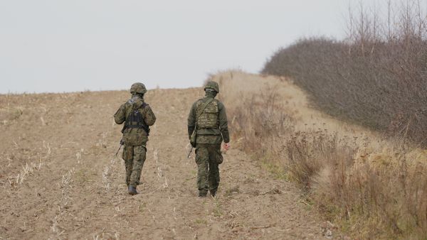 Soldiers patrol around the military base in Wiejki, Poland close to Belarusian border on November 13, 2021. Hundreds of desperate migrants are trapped in freezing temperatures on the border and the presence of troops from both sides has raised fears of a confrontation. (Photo by JANEK SKARZYNSKI / AFP) Middle Eastern asylum seekers have been repeatedly pushed back
