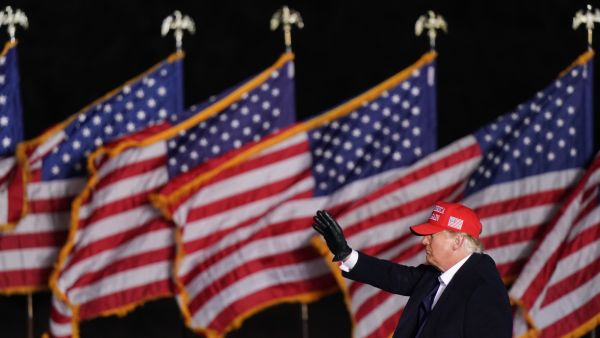 Former US President Donald Trump waves to the crowd at the end of a rally at the Florence Regional Airport on March 12, 2022 in Florence, South Carolina. Todays visit by Trump is his first rally in South Carolina since his election loss in 2020. Sean Rayford/Getty Images/AFP Former US President Donald Trump
