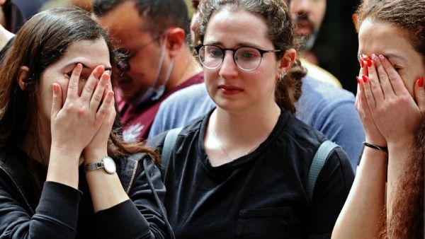 Israelis react at the site of a shooting attack in Tel Aviv 