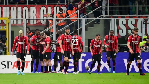 AC Milan's Portuguese forward Rafael Leao (2nd L) celebrates with teammates after scoring his team's first goal during the Italian Serie A football match between AC Milan and Genoa at the Giuseppe Meazza Stadium - also called San Siro in Milan, on April 15, 2022. (Photo by MIGUEL MEDINA / AFP)