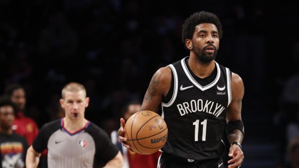 Kyrie Irving #11 of the Brooklyn Nets dribbles during the first half of the Eastern Conference 2022 Play-In Tournament against the Cleveland Cavaliers at Barclays Center on April 12, 2022 in the Brooklyn borough of New York City. (Photo by Sarah Stier / GETTY IMAGES NORTH AMERICA / Getty Images via AFP)